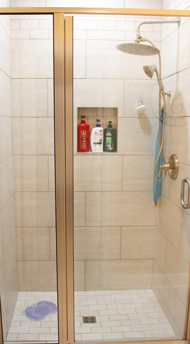 bathroom featuring a shower with shower door