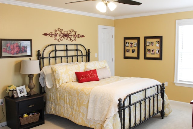 carpeted bedroom with ceiling fan, multiple windows, and ornamental molding