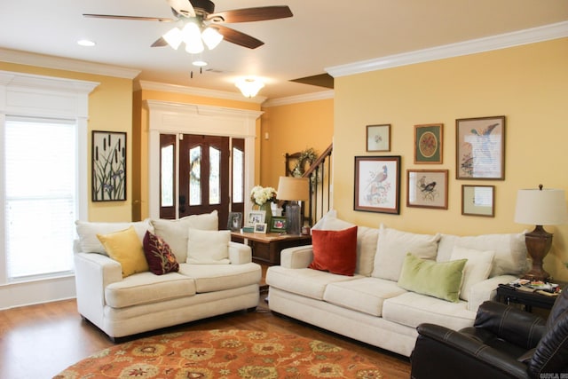 living room with ornamental molding, wood-type flooring, and ceiling fan