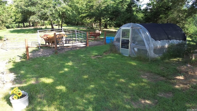 view of yard with a rural view and an outdoor structure