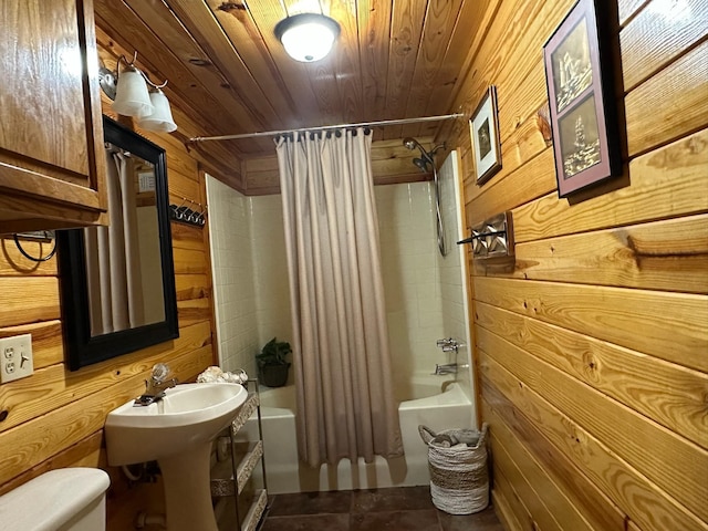 bathroom featuring toilet, wood ceiling, shower / tub combo with curtain, and wood walls