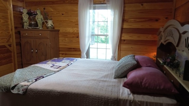 bedroom with wooden walls