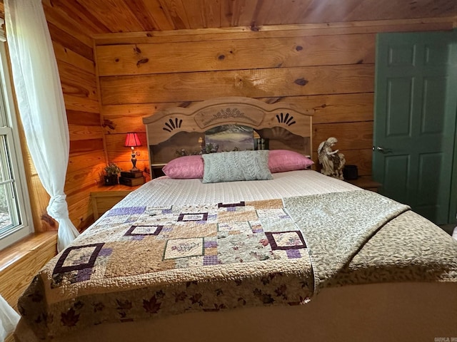 bedroom with wooden ceiling and wood walls