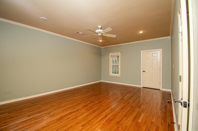 spare room featuring crown molding, light wood-type flooring, and ceiling fan