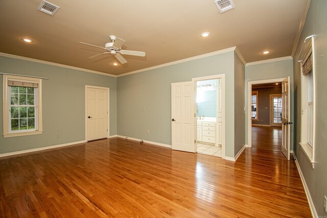 empty room with ornamental molding, sink, ceiling fan, and light wood-type flooring