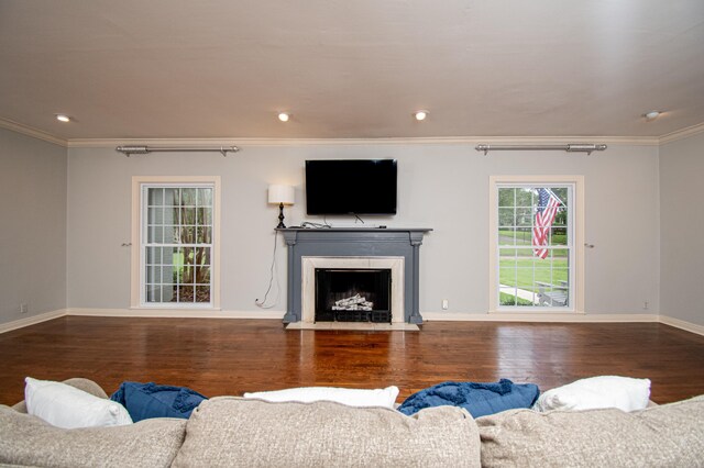 living room featuring hardwood / wood-style flooring and crown molding