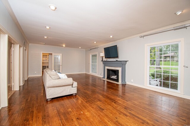 unfurnished living room with ornamental molding and wood-type flooring