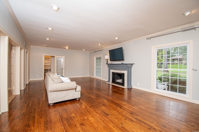 unfurnished living room with baseboards, a fireplace with flush hearth, wood-type flooring, ornamental molding, and recessed lighting