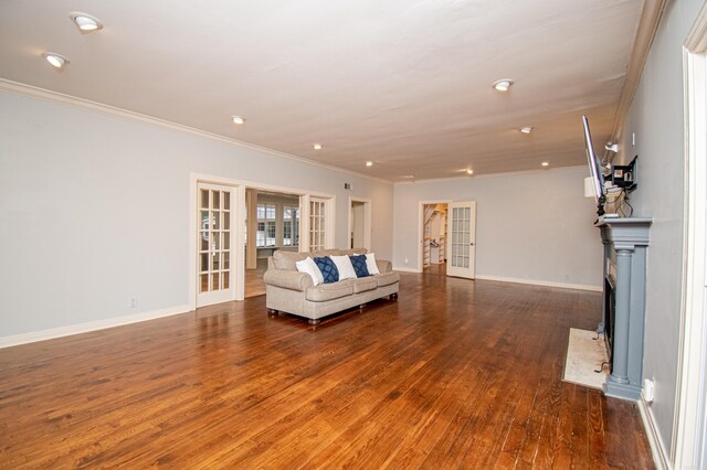 unfurnished living room featuring hardwood / wood-style flooring, french doors, and ornamental molding