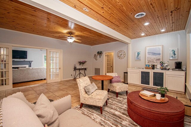 tiled living room with wooden ceiling, ceiling fan, and french doors