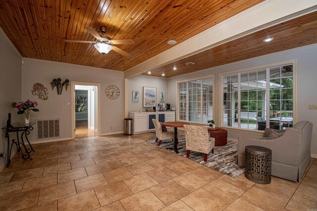 tiled living room with wood ceiling and ceiling fan