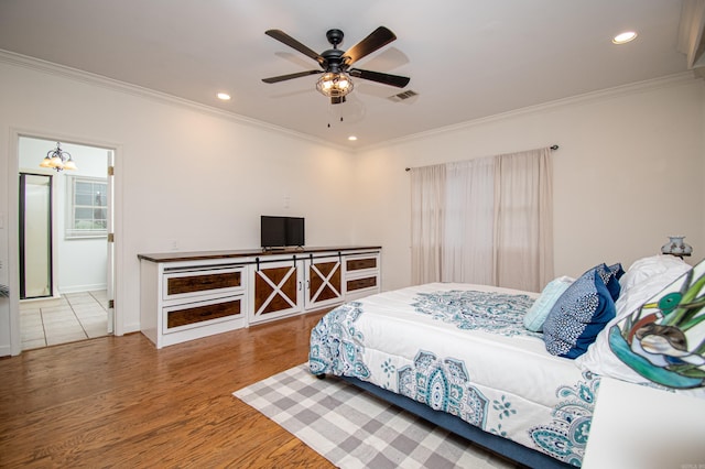 bedroom featuring crown molding, hardwood / wood-style floors, and ceiling fan