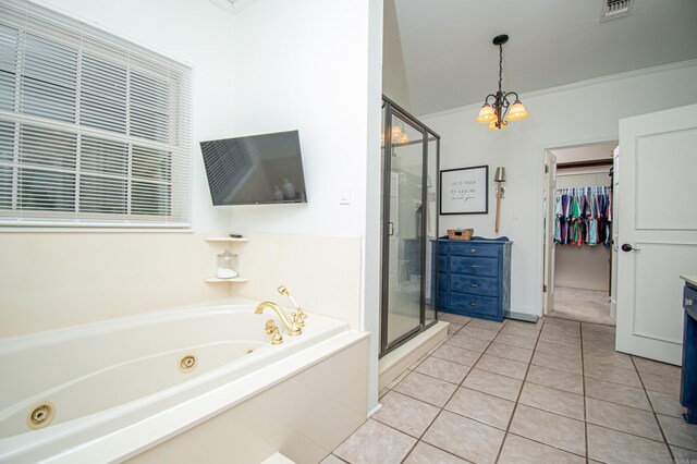 bathroom featuring plus walk in shower, vanity, crown molding, and tile patterned flooring