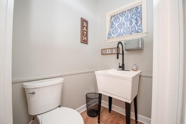 bathroom with toilet and tile patterned floors