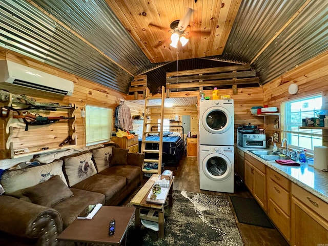 laundry room with a wall mounted air conditioner, wood walls, stacked washer / dryer, dark wood-type flooring, and ceiling fan