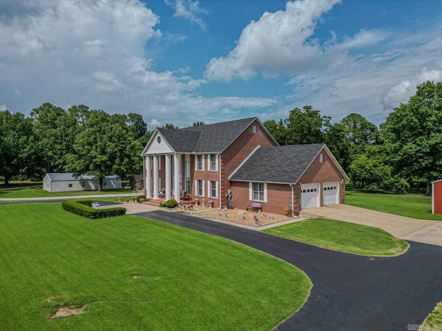 view of front of home featuring a garage and a front yard