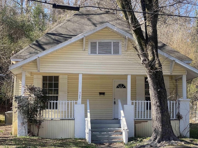 bungalow featuring a shingled roof and a porch