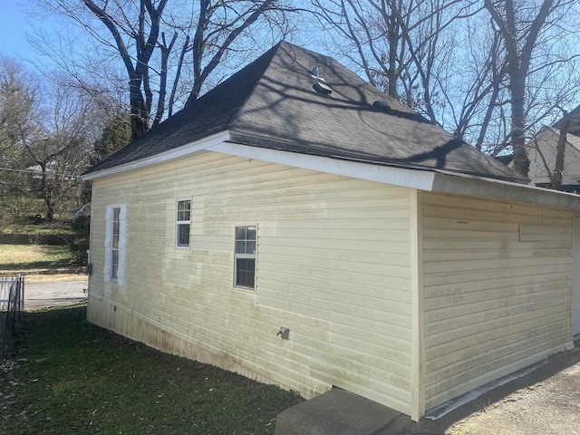 view of property exterior featuring a shingled roof