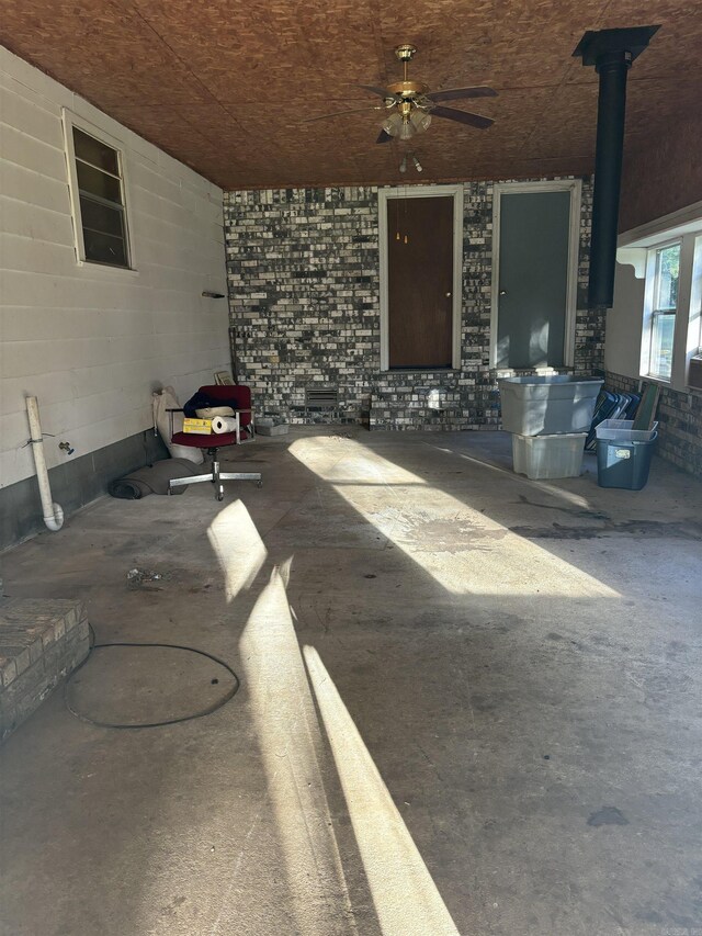 recreation room featuring sink, wooden walls, and ceiling fan