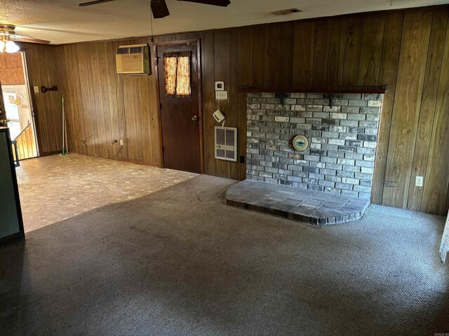 carpeted bedroom featuring ceiling fan, a textured ceiling, and wooden walls