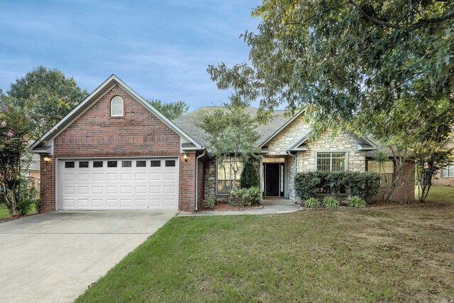 view of front of property with a garage and a front lawn