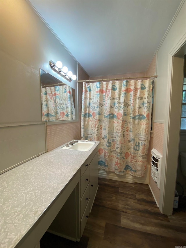 bathroom with vanity, hardwood / wood-style flooring, and crown molding