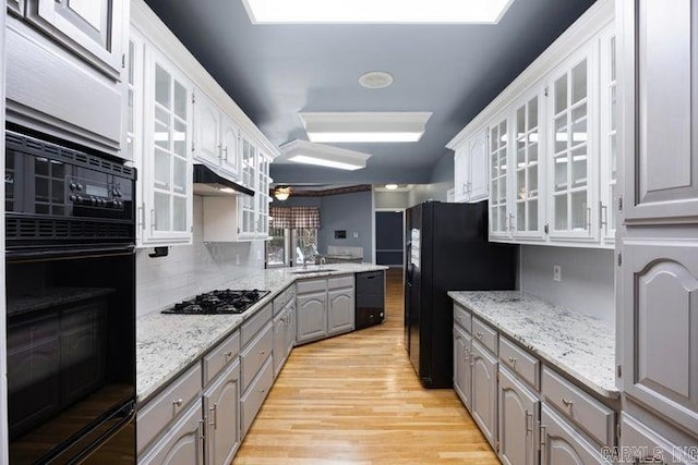 254 S Enid Ave, Russellville, AR 72801 - kitchen featuring tasteful backsplash, black appliances, gray cabinets, light stone countertops, and light wood-type flooring
