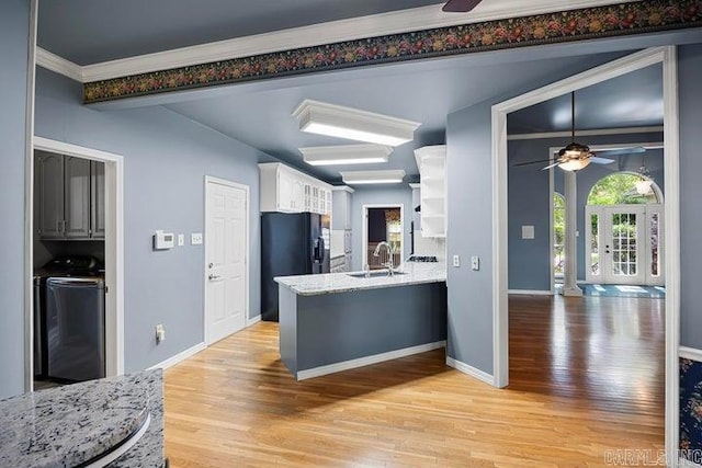 254 S Enid Ave, Russellville, AR 72801 - kitchen featuring white cabinets, sink, light hardwood / wood-style floors, washer / dryer, and ceiling fan