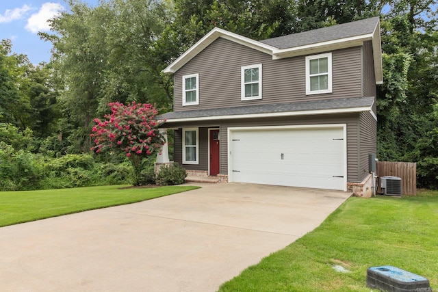 view of front of property with cooling unit, a garage, and a front yard