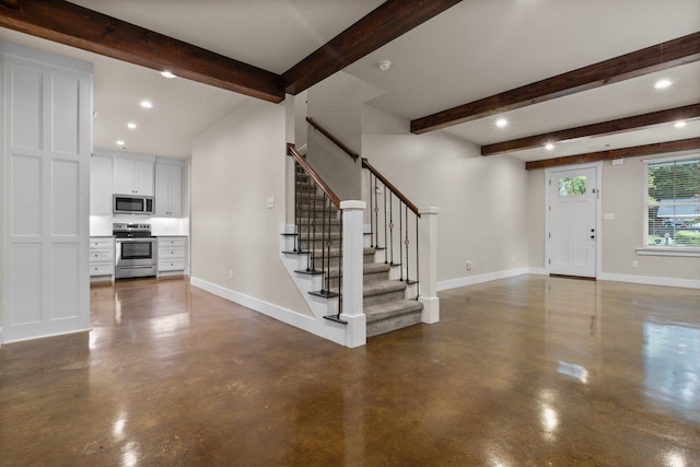 foyer entrance with beamed ceiling