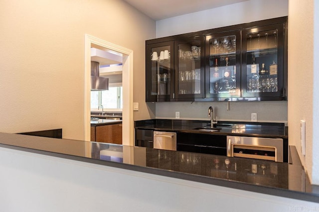 bar featuring sink, stainless steel dishwasher, and wine cooler