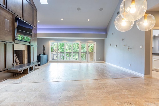 unfurnished living room with a towering ceiling