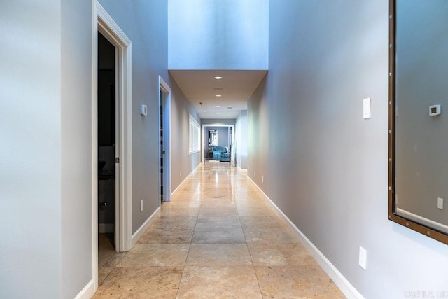 corridor featuring a towering ceiling