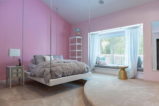 bedroom featuring lofted ceiling and carpet