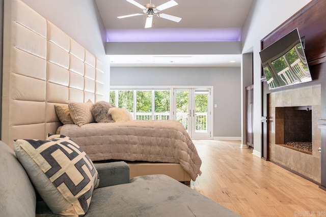 bedroom featuring ceiling fan, access to outside, and light wood-type flooring