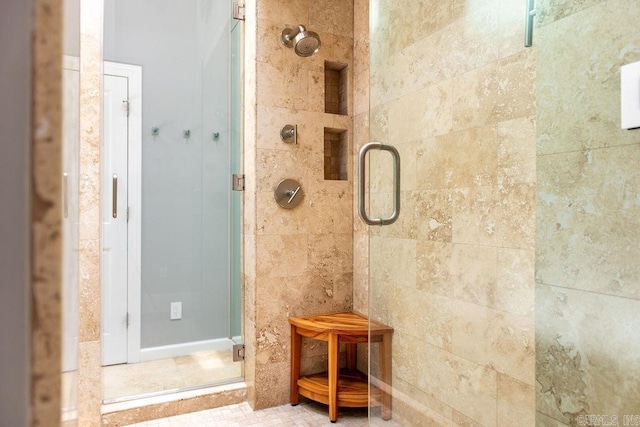 bathroom with a shower with shower door