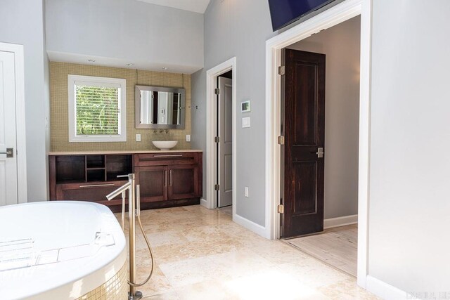 bathroom with vanity and a tub