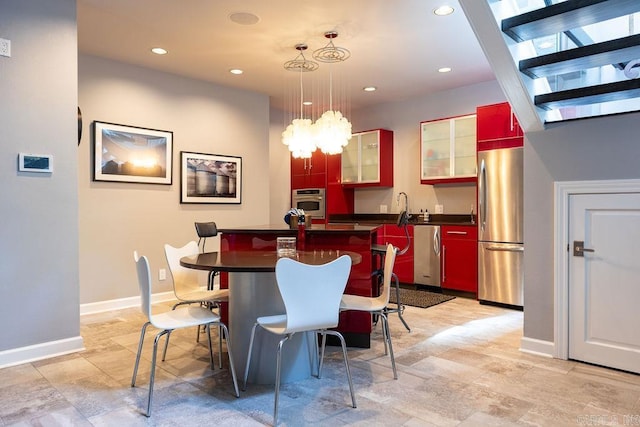 kitchen featuring pendant lighting, appliances with stainless steel finishes, and a kitchen island