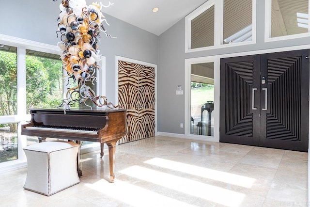 interior space featuring french doors, a high ceiling, and a wealth of natural light