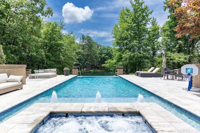 view of swimming pool featuring pool water feature, an outdoor hangout area, and a patio