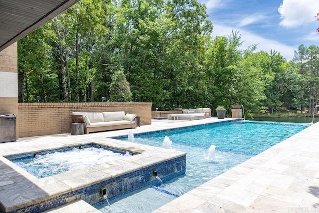 view of swimming pool with pool water feature, an outdoor living space, and an in ground hot tub