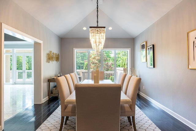 dining room featuring an inviting chandelier, lofted ceiling, and dark hardwood / wood-style flooring