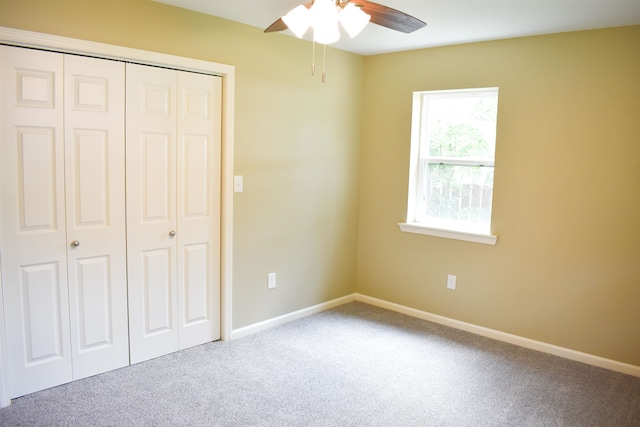 unfurnished bedroom featuring a closet, ceiling fan, and carpet floors