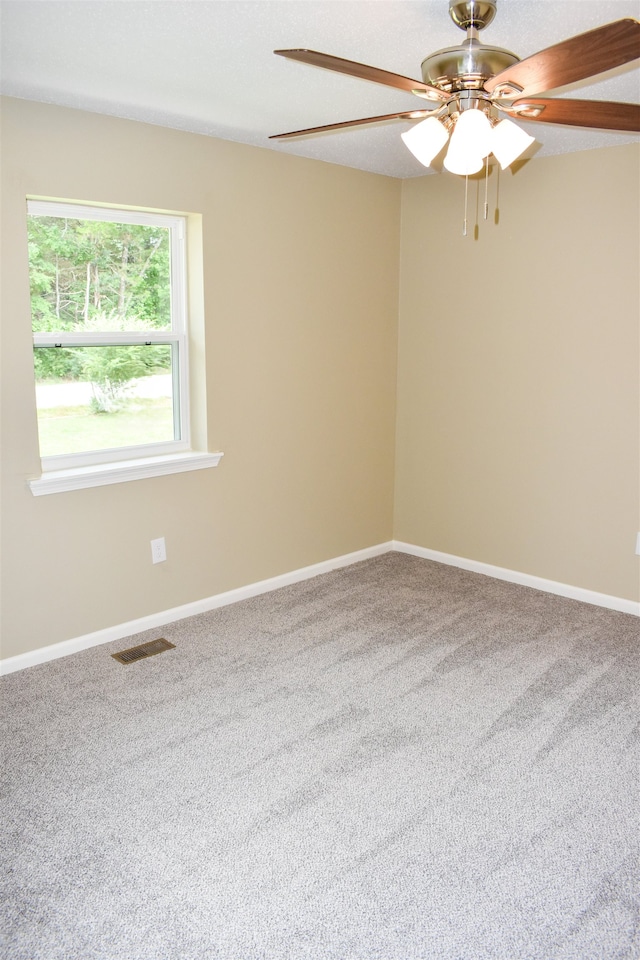 unfurnished room featuring ceiling fan and carpet floors