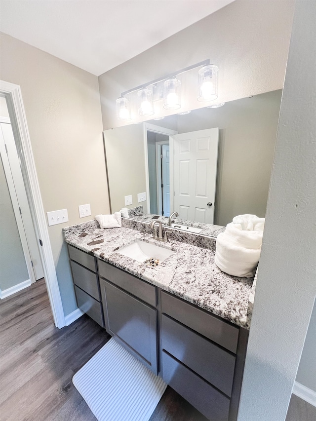 bathroom with vanity and hardwood / wood-style flooring