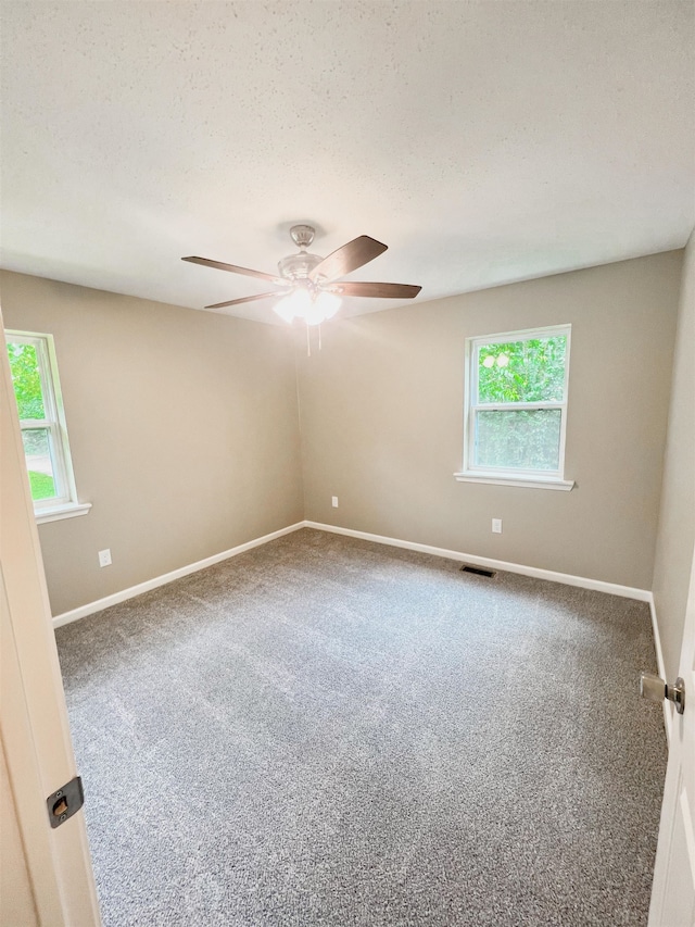 spare room with ceiling fan, carpet floors, and a textured ceiling