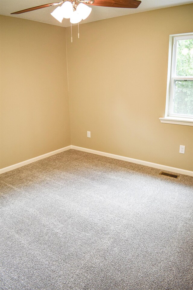 spare room with carpet floors and ceiling fan