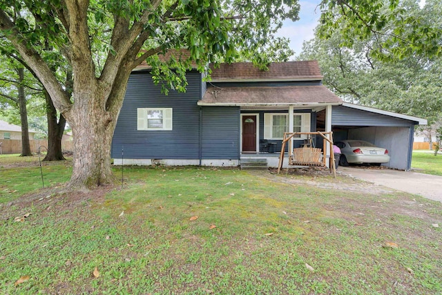 view of front facade with a carport, covered porch, and a front lawn