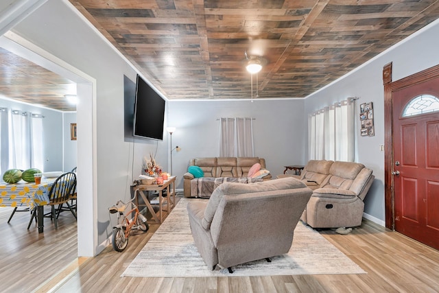 living room featuring ornamental molding, a healthy amount of sunlight, and light hardwood / wood-style floors