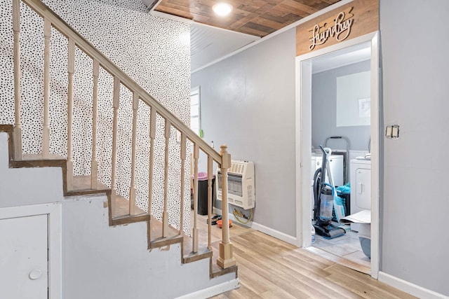 stairway with hardwood / wood-style flooring, independent washer and dryer, heating unit, and wooden ceiling